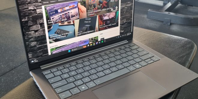 Lenovo Yoga Pro 7i Aura Edition Gen 10 sitting open on a gym bench with The Empire NZ website landing page open